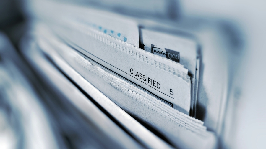Files of paper with focus on file labelled classified.