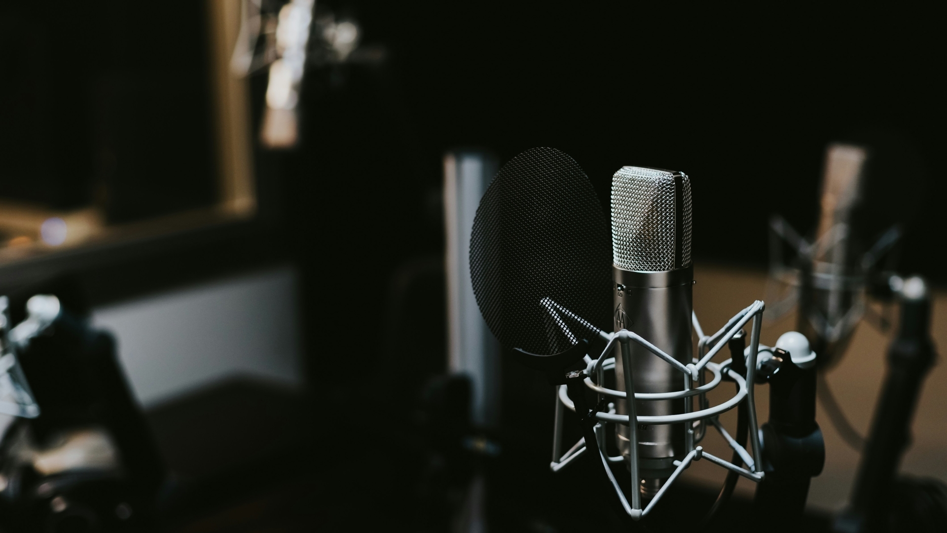 Podcast studio with microphones in focus.
