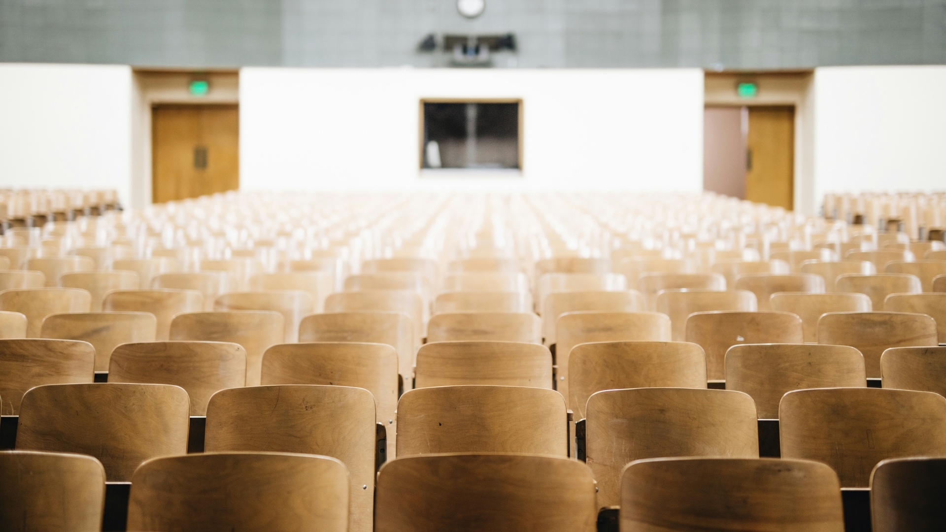 Large auditorium facing empty chairs where presentations would be held.