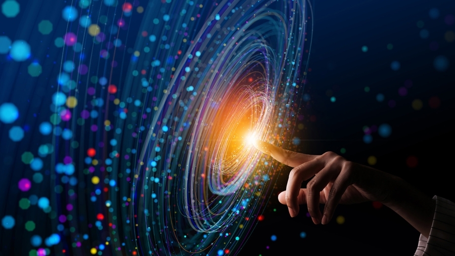 Light emanating from someone's fingertip, with data floating all around.