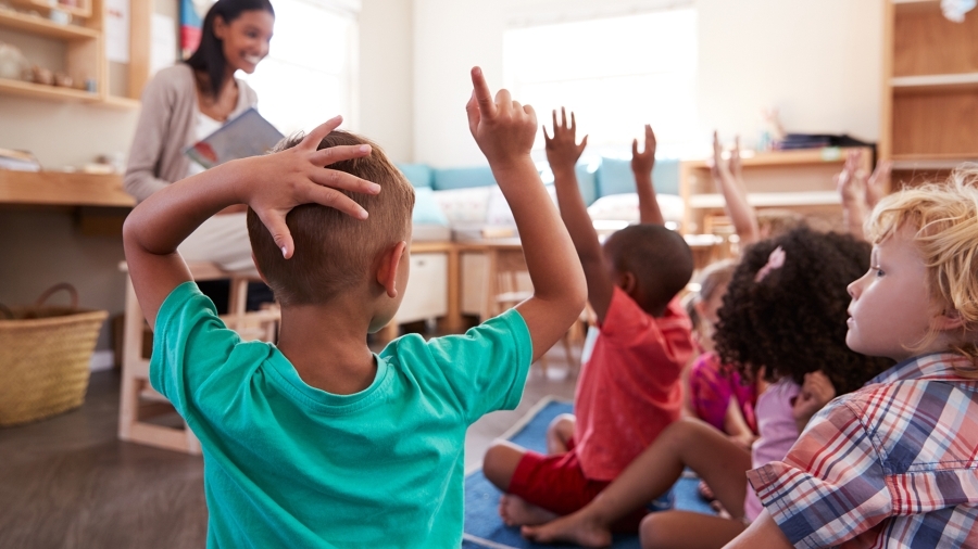 Children asking questions in a classroom.