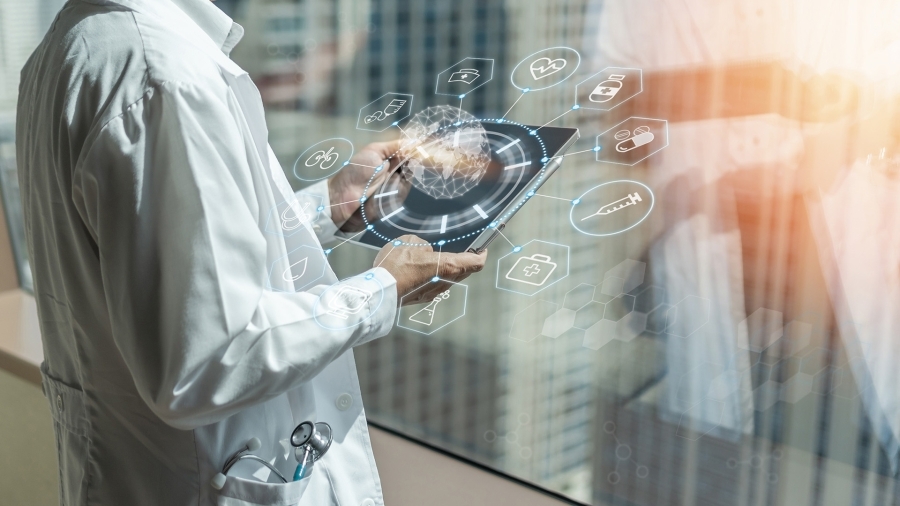 A doctor holding an iPad looking at medical data.