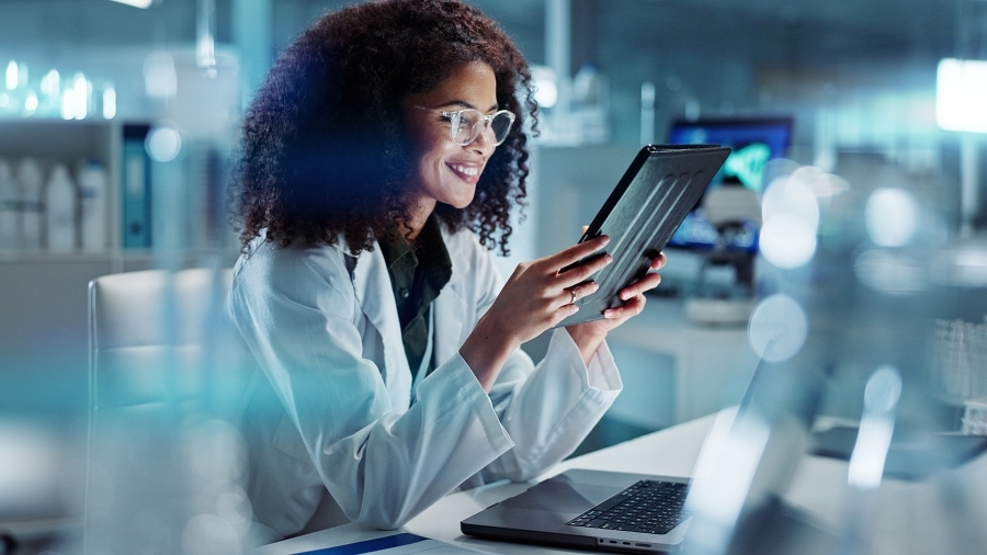 A healthcare professional using a tablet.