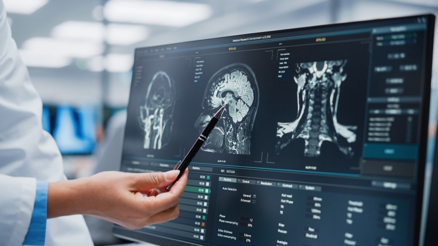 A doctor looking at x-rays on a computer screen.