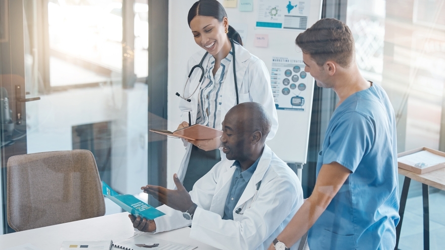 A group of doctors gathered around a table.
