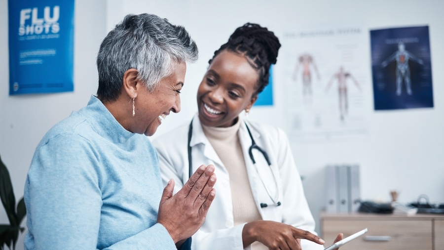 A doctor and patient smiling together.