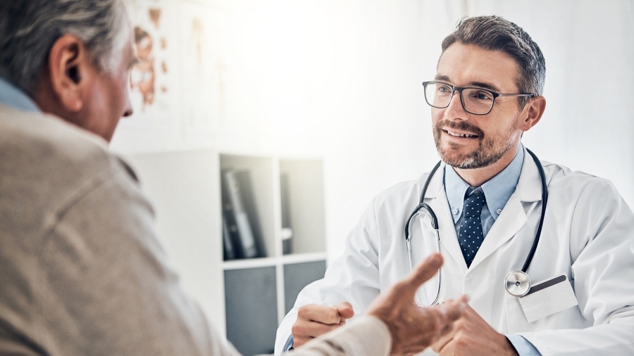 A doctor talking to an elderly patient.
