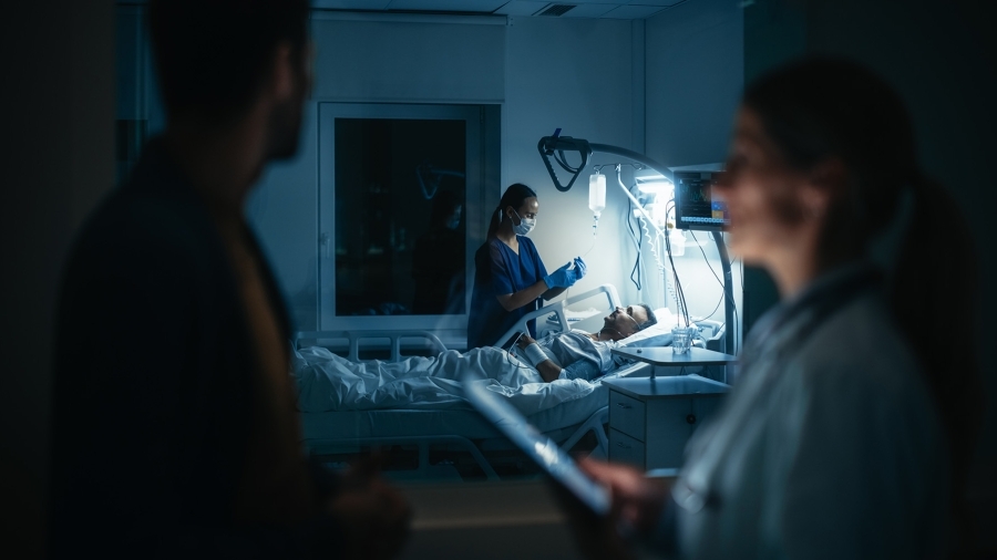 A nurse taking care of a bedridden patient.