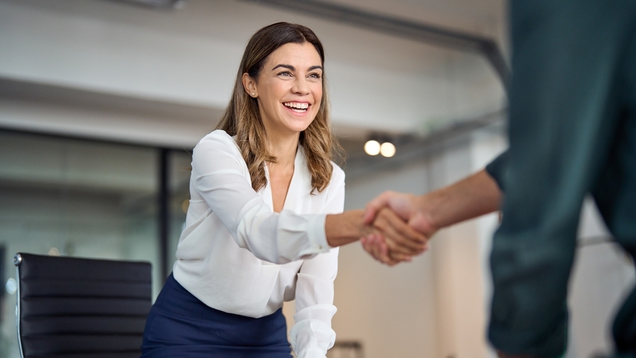 A businesswoman shaking someone's hand.