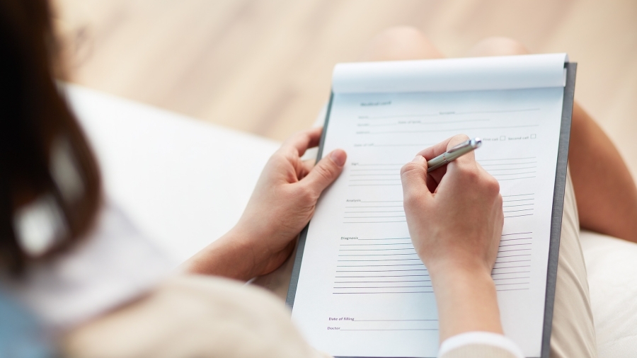 A woman filling in paperwork.
