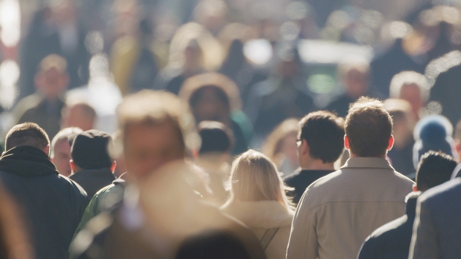 A crowd of people walking downtown.