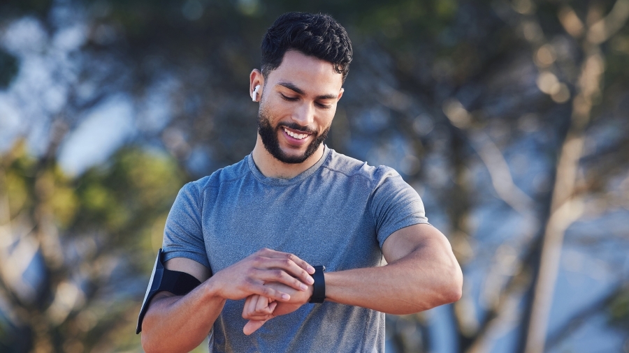 A man using a smart watch while exercising.