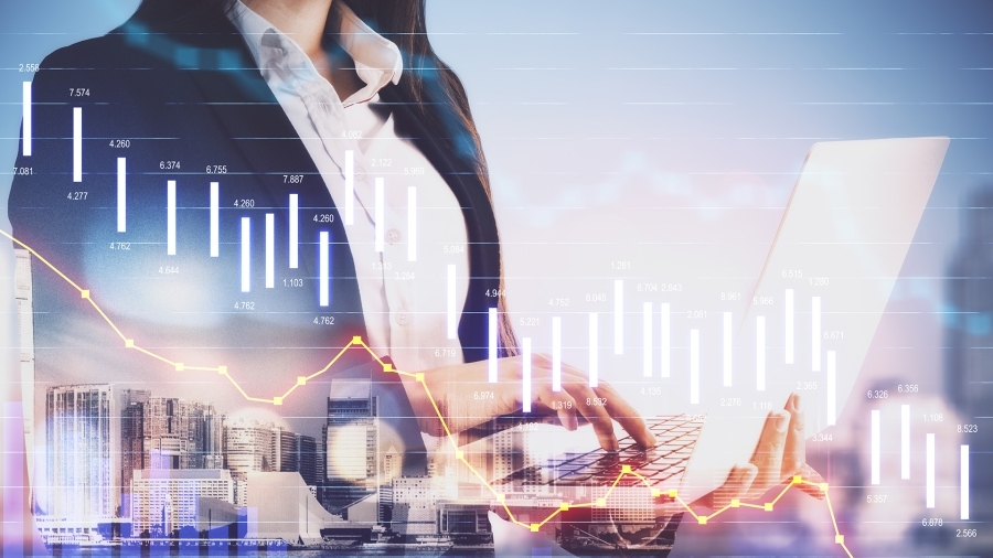 A woman holding a laptop, with graphs and data points superimposed on top.