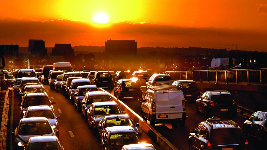 Cars driving on the highway during rush hour.