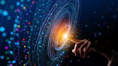 Light emanating from someone's fingertip, with data floating all around.