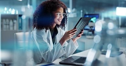 A healthcare professional using a tablet.