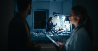 A nurse taking care of a bedridden patient.