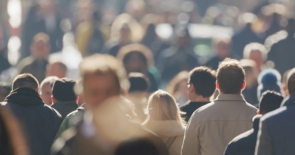 A crowd of people walking downtown.
